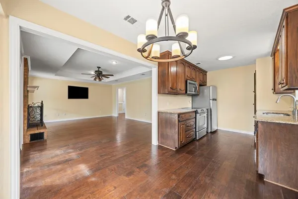 a view of a kitchen with a sink stainless steel appliances and cabinets