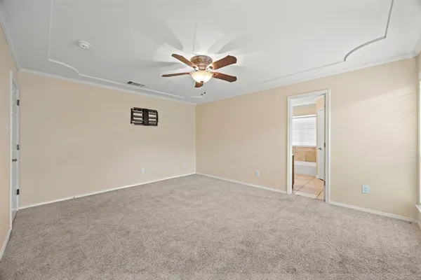 an empty room with closet and a chandelier fan