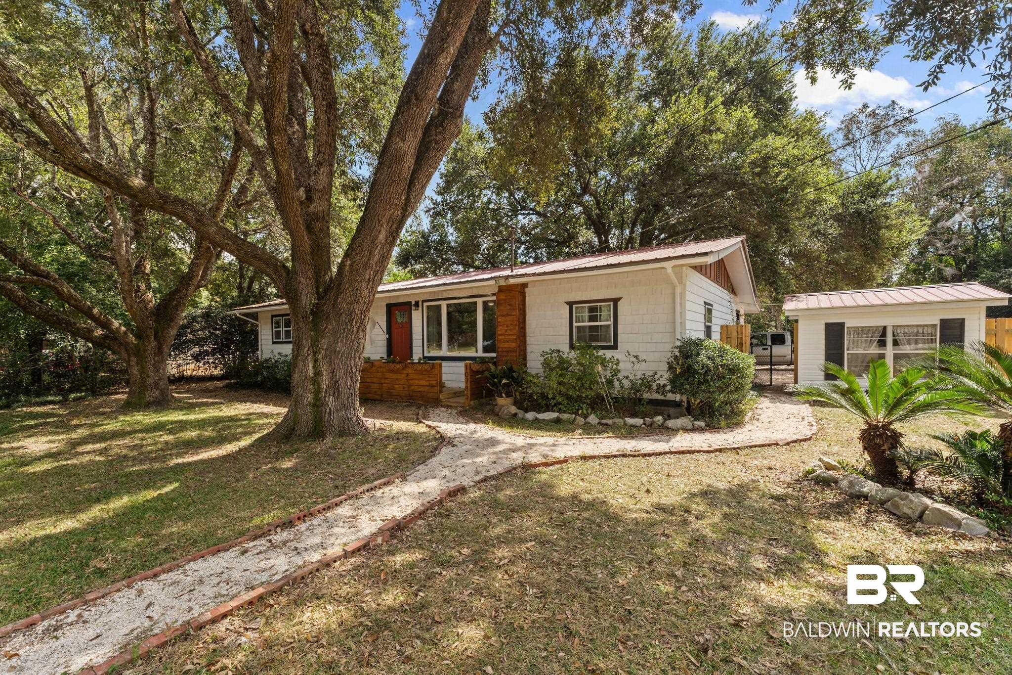 10785 Gregg Road Semmes, AL 36575 - Photo 29 of 35 Ranch-style home featuring a metal roof and a front yard