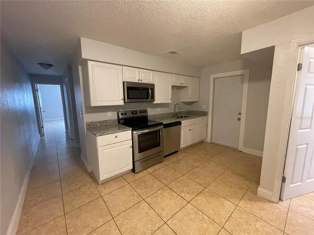 a kitchen with cabinets and steel stainless steel appliances
