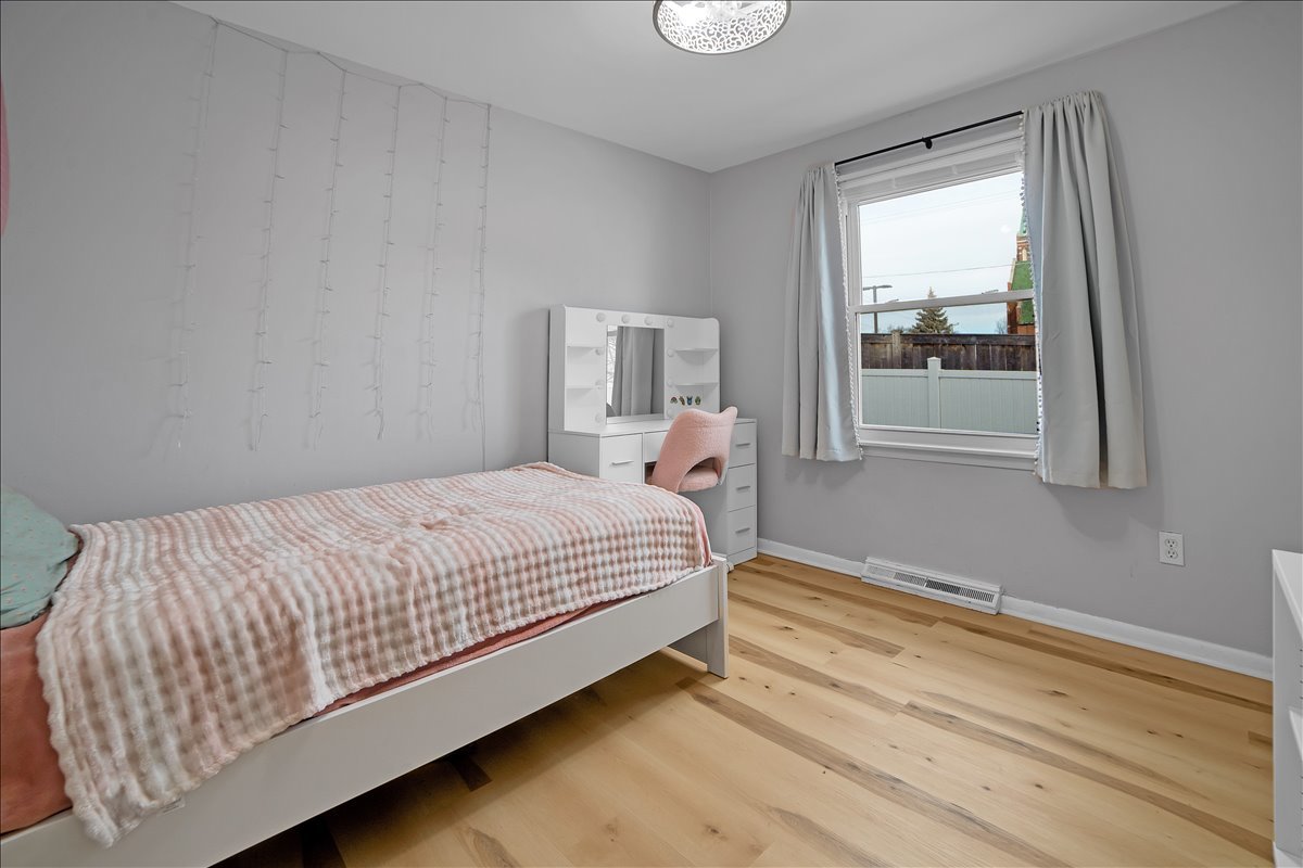 705 State Street Lemont, IL 60439 - Photo 12 of 31 a bed sitting in a bedroom next to a window