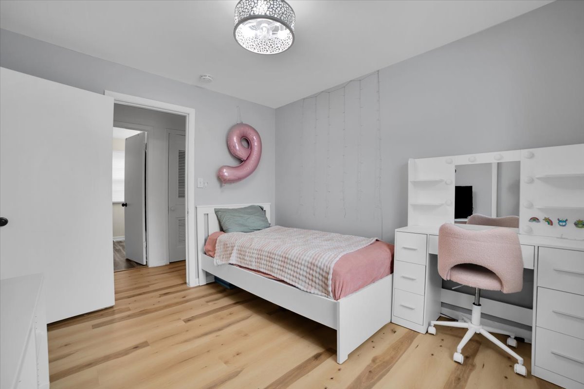 705 State Street Lemont, IL 60439 - Photo 13 of 31 a bedroom with a bed and a chair in it