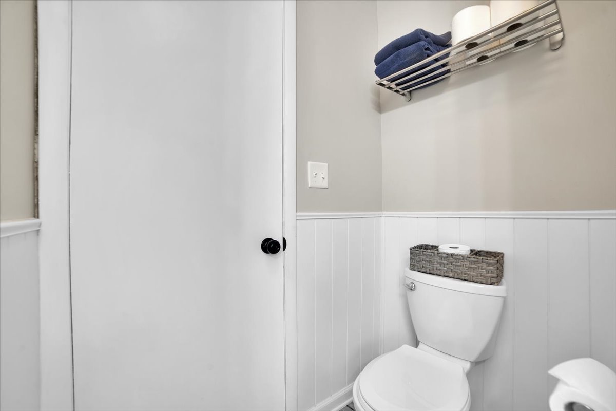 705 State Street Lemont, IL 60439 - Photo 16 of 31 a white toilet sitting next to a shower