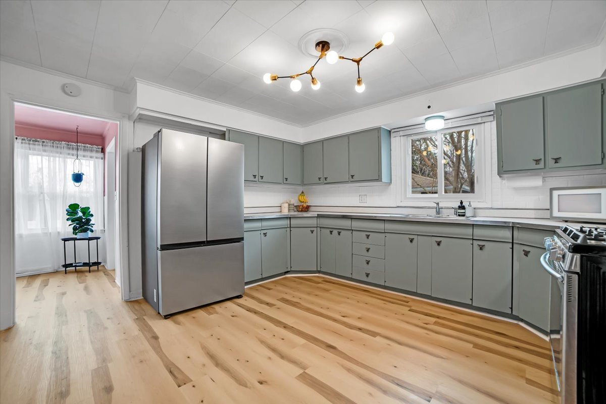 705 State Street Lemont, IL 60439 - Photo 20 of 31 a kitchen with stainless steel appliances granite countertop a refrigerator sink and white cabinets