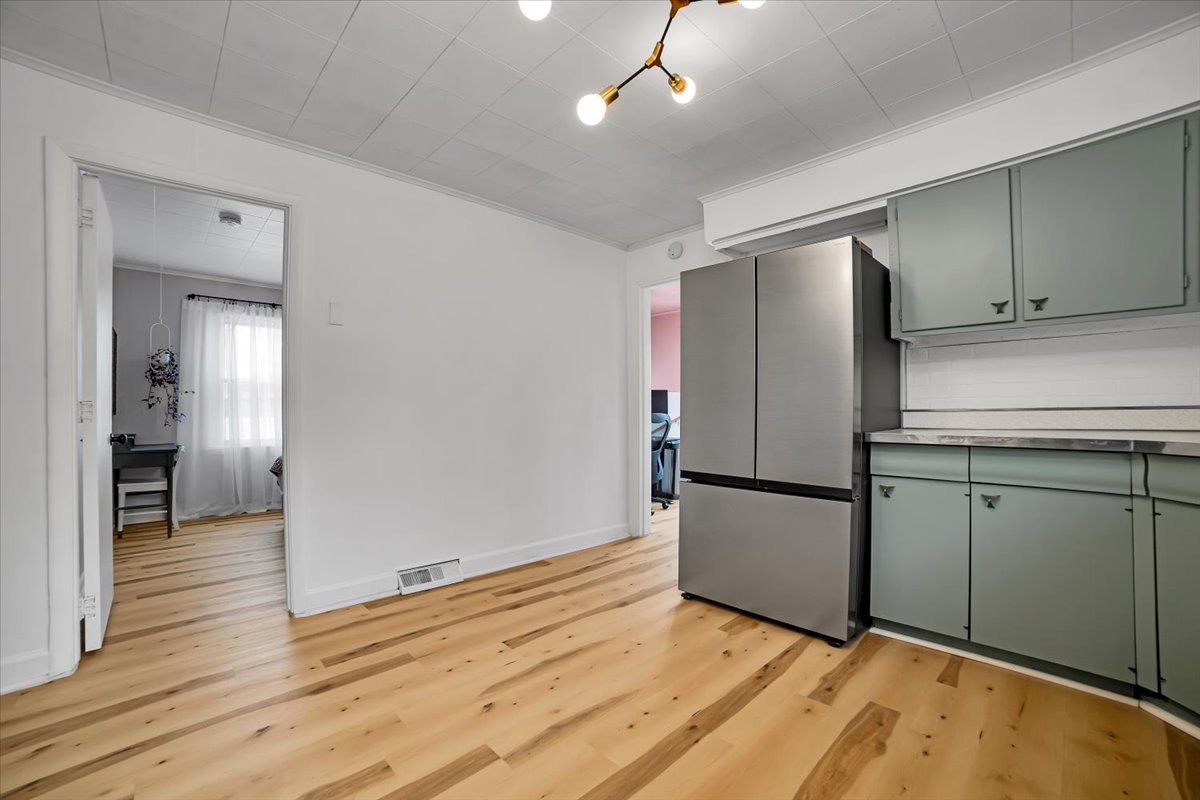 705 State Street Lemont, IL 60439 - Photo 21 of 31 a kitchen with a refrigerator and a wooden floor