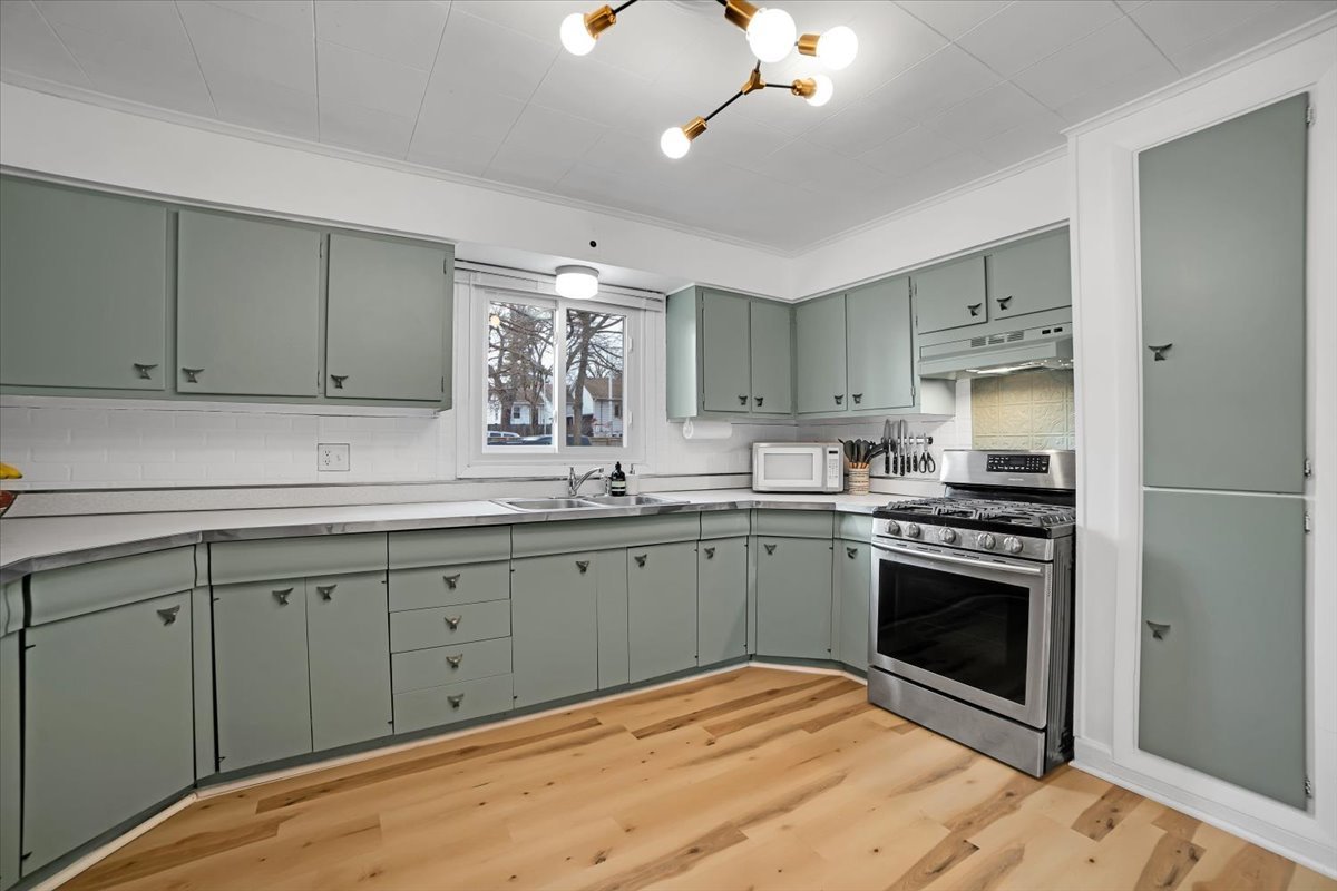 705 State Street Lemont, IL 60439 - Photo 23 of 31 a kitchen with stainless steel appliances granite countertop a stove and a sink