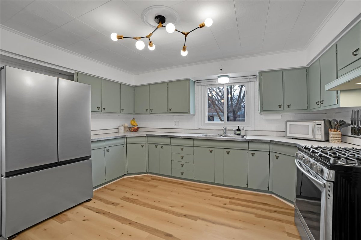 705 State Street Lemont, IL 60439 - Photo 24 of 31 a kitchen with a sink appliances and cabinets