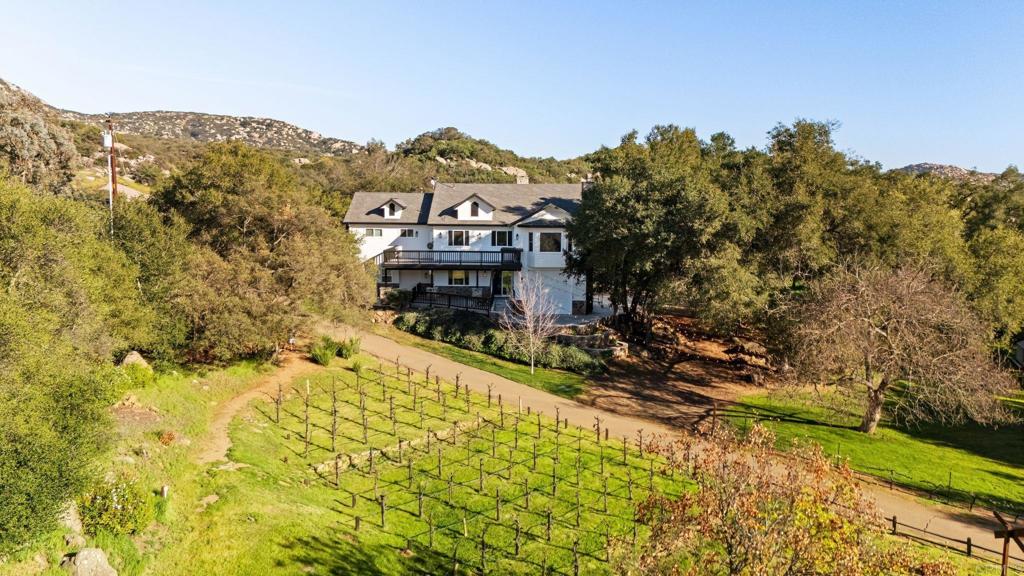 14671 Mussey Grade Road Ramona, CA 92065 - Photo 1 of 36 a view of a houses with a yard