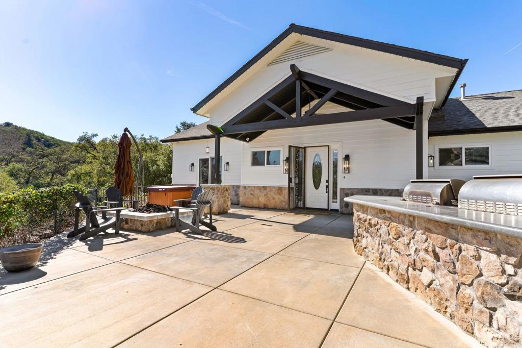 14671 Mussey Grade Road Ramona, CA 92065 - Photo 11 of 36 a view of a patio with a table and chairs under an umbrella