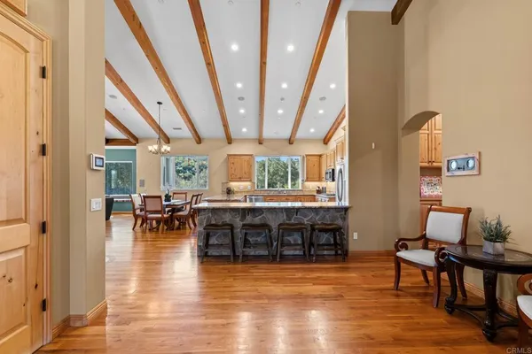 a large kitchen with stainless steel appliances granite countertop a stove and cabinets