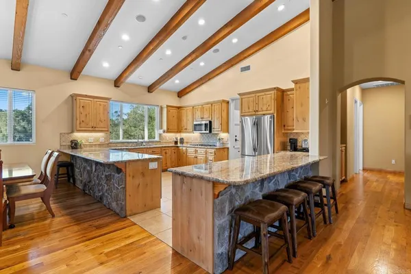 a dining room with furniture a fireplace and wooden floor