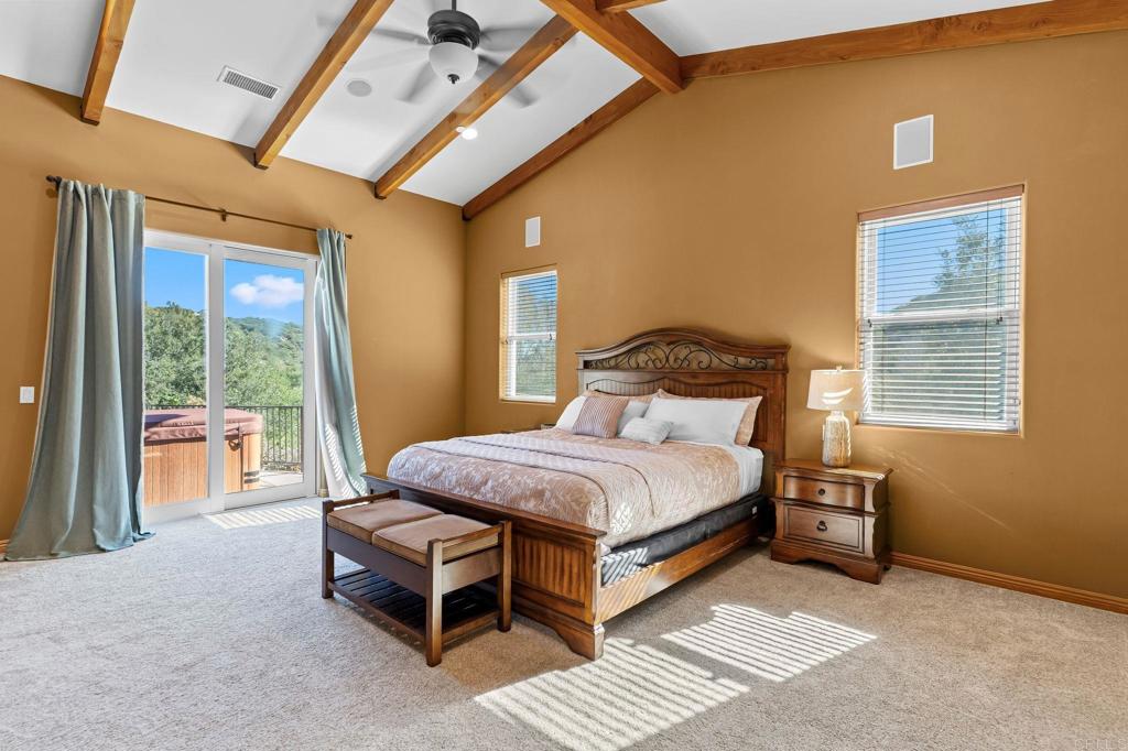 14671 Mussey Grade Road Ramona, CA 92065 - Photo 17 of 36 a bedroom with a bed chair and a large window