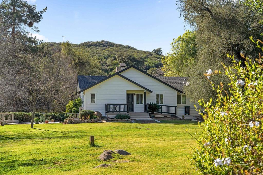 14671 Mussey Grade Road Ramona, CA 92065 - Photo 27 of 36 a view of a house with a big yard and swimming pool