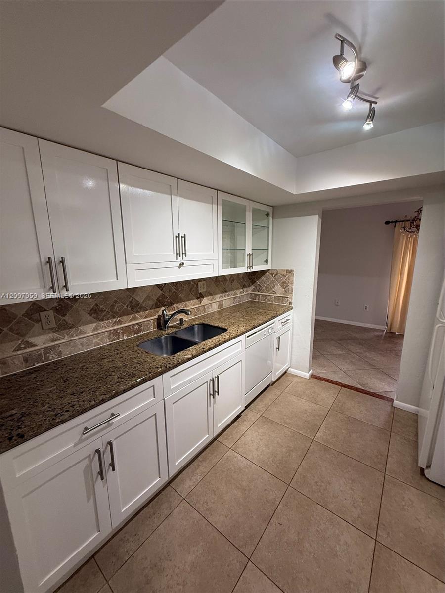10661 Southwest 113th Place, Unit 94B Miami, FL 33176 - Photo 12 of 54 a large kitchen with cabinets