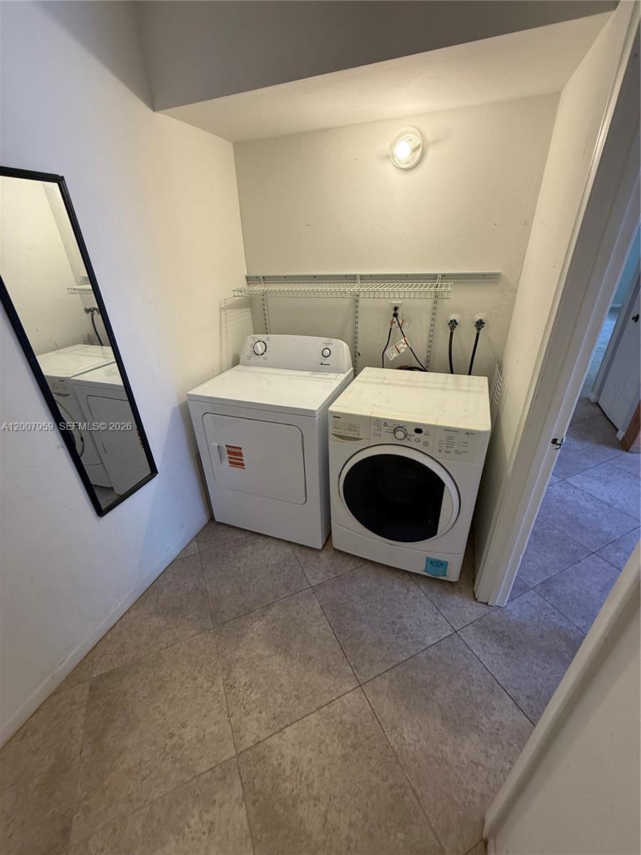 10661 Southwest 113th Place, Unit 94B Miami, FL 33176 - Photo 16 of 54 a utility room with dryer and washer