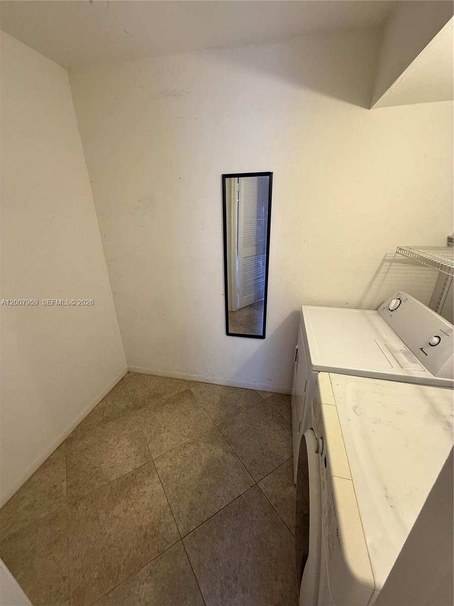 10661 Southwest 113th Place, Unit 94B Miami, FL 33176 - Photo 17 of 54 a utility room with dryer and washer