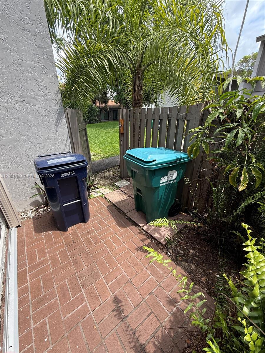 10661 Southwest 113th Place, Unit 94B Miami, FL 33176 - Photo 20 of 54 a view of a backyard with plants and a garden