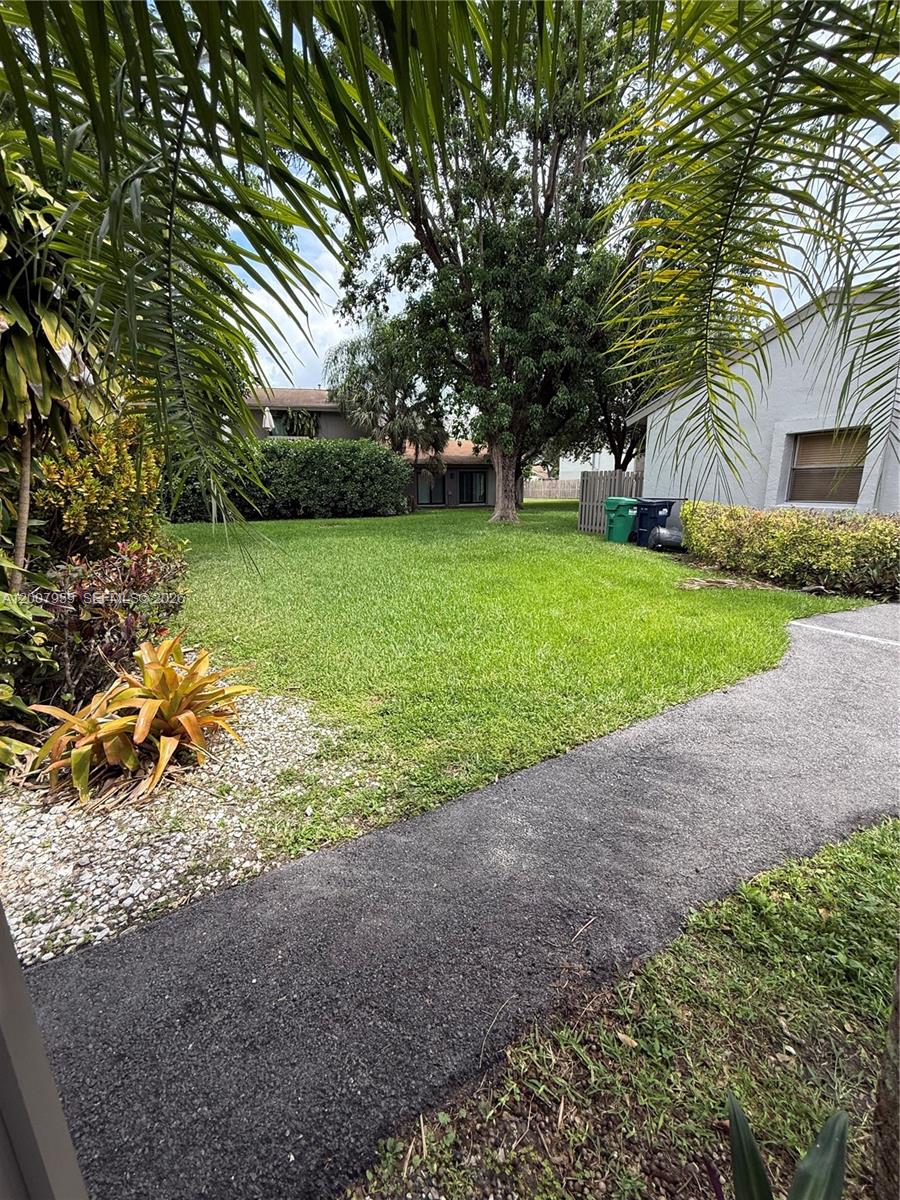 10661 Southwest 113th Place, Unit 94B Miami, FL 33176 - Photo 23 of 54 a view of a house with a back yard