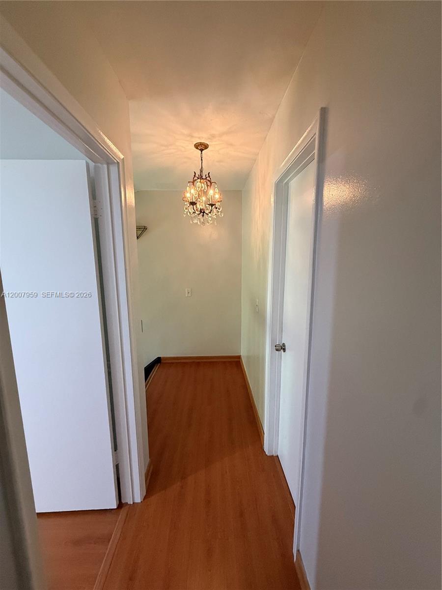 10661 Southwest 113th Place, Unit 94B Miami, FL 33176 - Photo 25 of 54 a view of a hallway with wooden floor