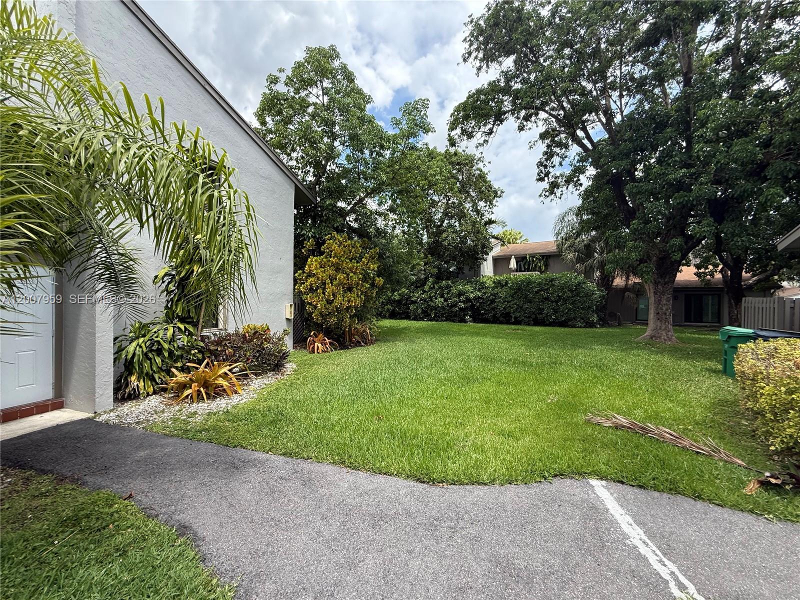 10661 Southwest 113th Place, Unit 94B Miami, FL 33176 - Photo 3 of 54 a view of a garden with a fountain