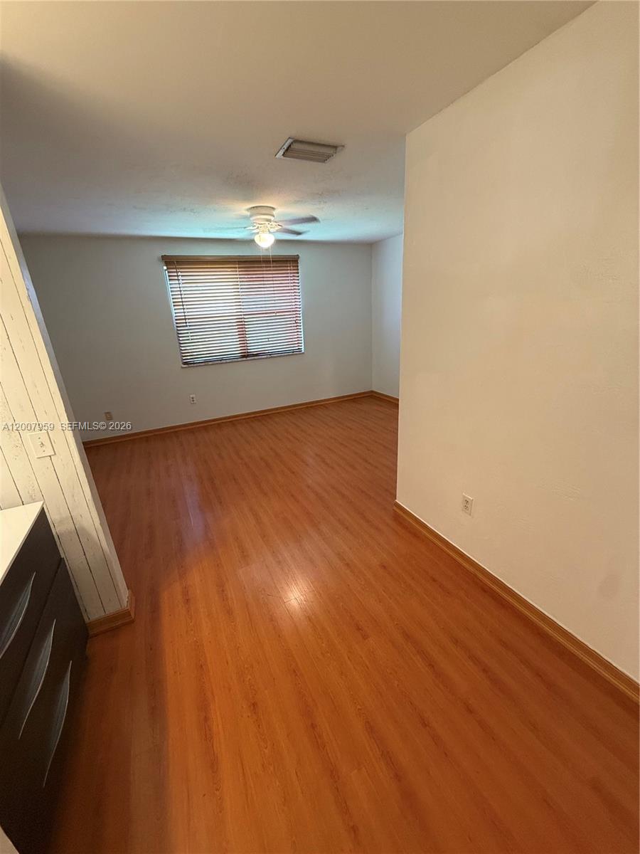 10661 Southwest 113th Place, Unit 94B Miami, FL 33176 - Photo 31 of 54 a view of empty room with wooden floor