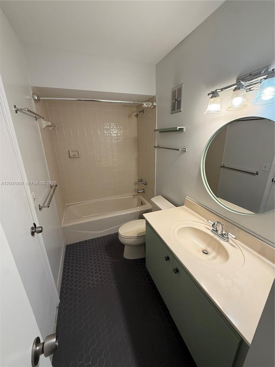 10661 Southwest 113th Place, Unit 94B Miami, FL 33176 - Photo 34 of 54 a bathroom with a sink a toilet and shower