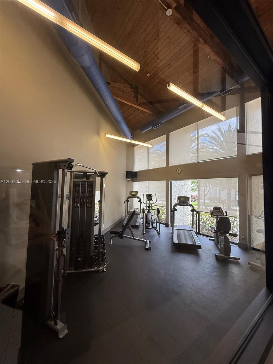 10661 Southwest 113th Place, Unit 94B Miami, FL 33176 - Photo 41 of 54 a view of a room with gym equipment