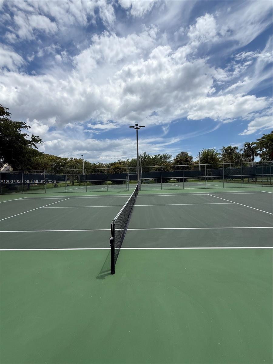 10661 Southwest 113th Place, Unit 94B Miami, FL 33176 - Photo 50 of 54 a view of a tennis court