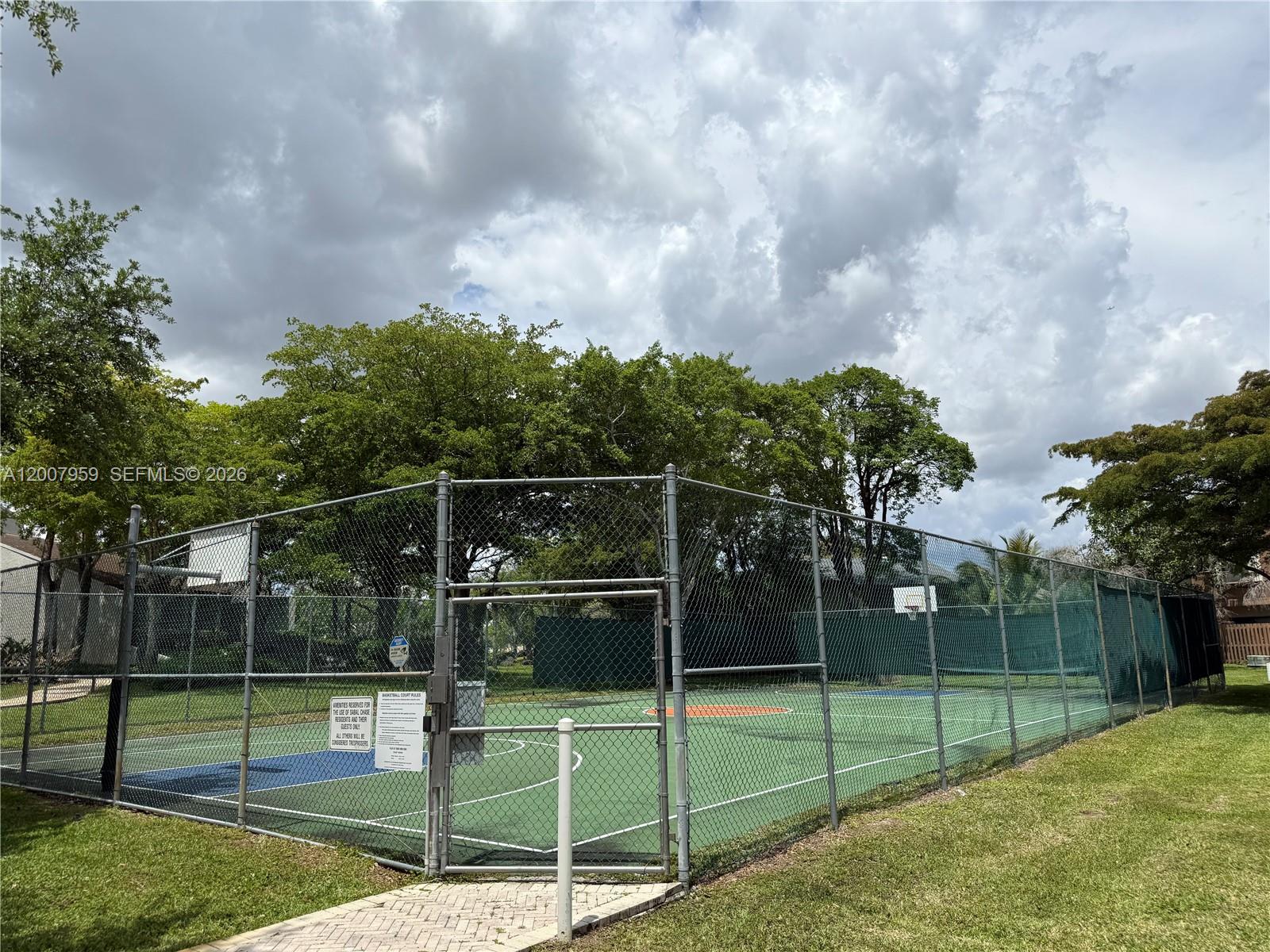 10661 Southwest 113th Place, Unit 94B Miami, FL 33176 - Photo 52 of 54 a view of a backyard with swings