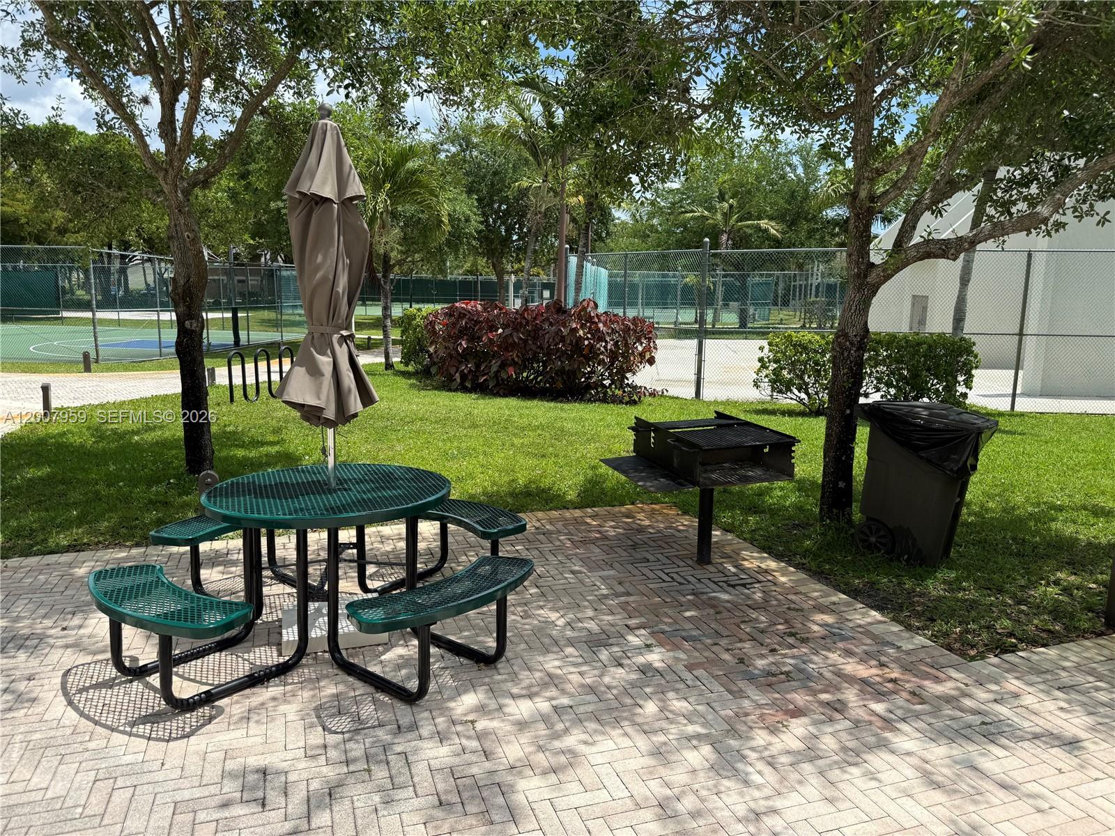 10661 Southwest 113th Place, Unit 94B Miami, FL 33176 - Photo 53 of 54 a view of a bench in a garden