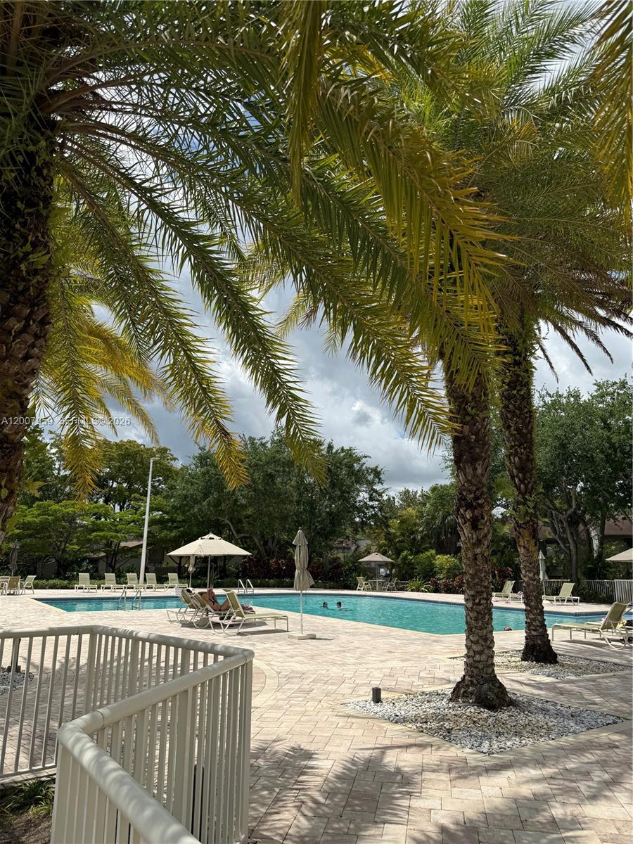 10661 Southwest 113th Place, Unit 94B Miami, FL 33176 - Photo 54 of 54 a view of a swimming pool with a patio