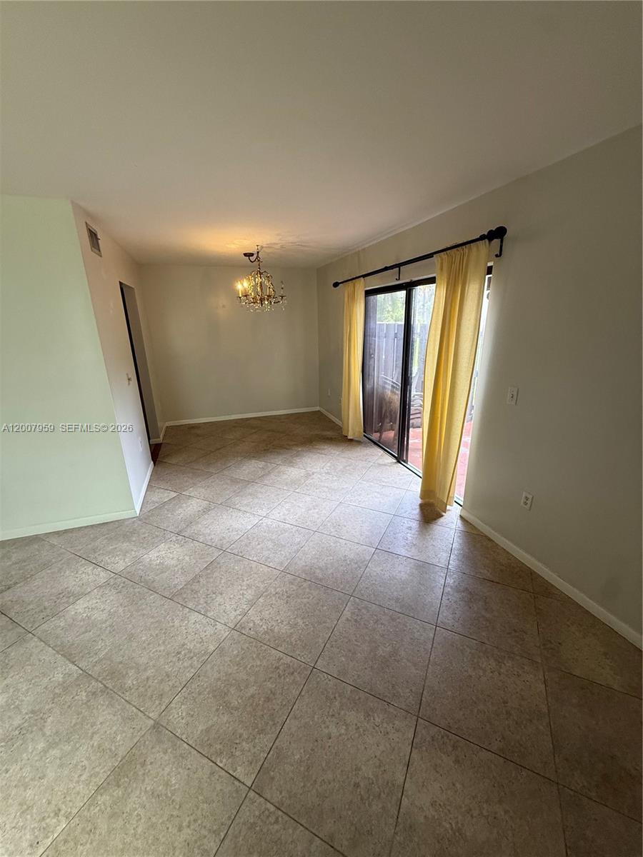 10661 Southwest 113th Place, Unit 94B Miami, FL 33176 - Photo 8 of 54 a view of a livingroom with an empty space and a fireplace
