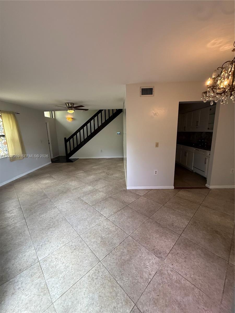10661 Southwest 113th Place, Unit 94B Miami, FL 33176 - Photo 10 of 54 a view of a livingroom with a staircase
