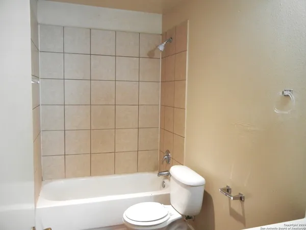 a bathroom with a toilet and a bath tub