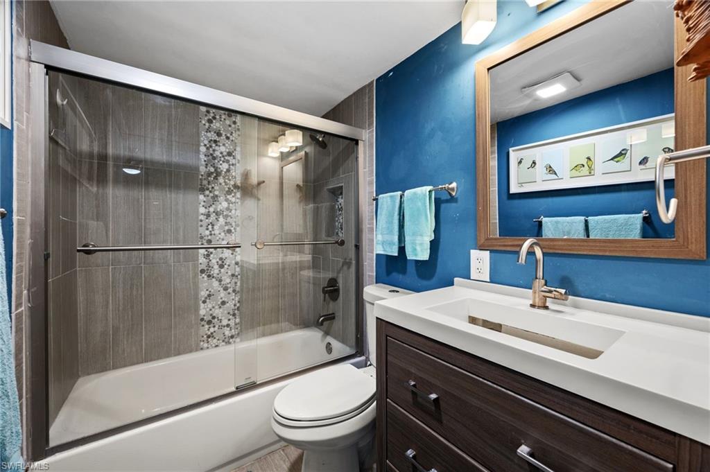 5800 Bonita Beach Road Southwest, Unit 2002 Bonita Springs, FL 34134 - Photo 10 of 24 a bathroom with a sink a toilet and shower