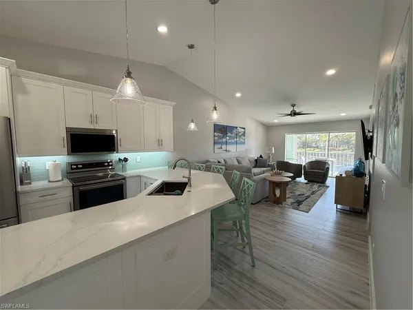 a kitchen with sink refrigerator and stove