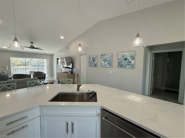 a kitchen with a sink a stove and cabinets