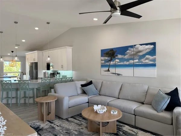 a living room with furniture a rug and a wall painting