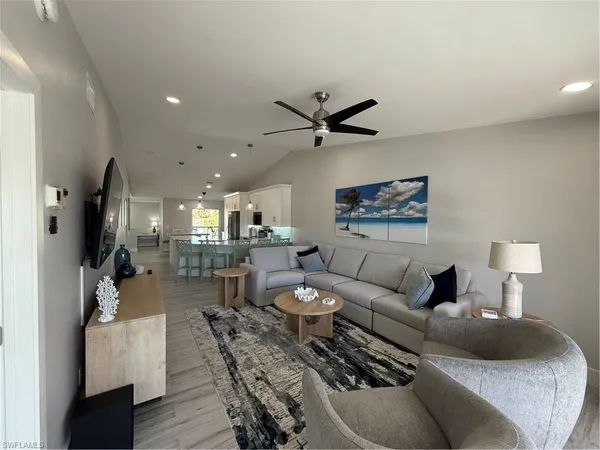 a living room with furniture and a flat screen tv