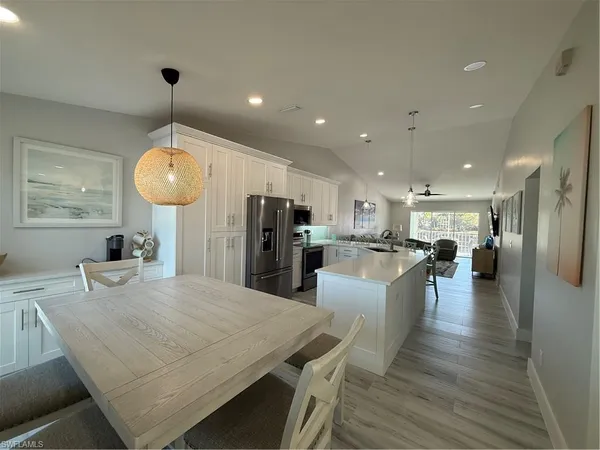 a large kitchen with a table and chairs