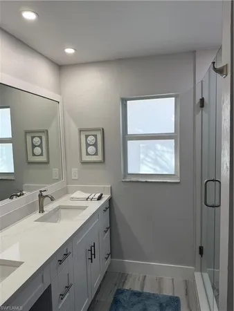a bathroom with a sink a vanity and a large mirror