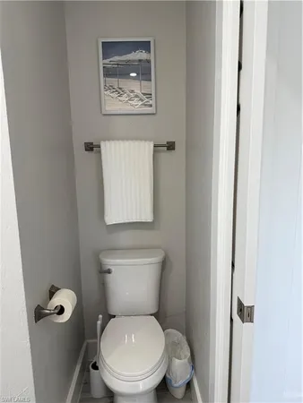 a white toilet sitting next to a bathroom sink