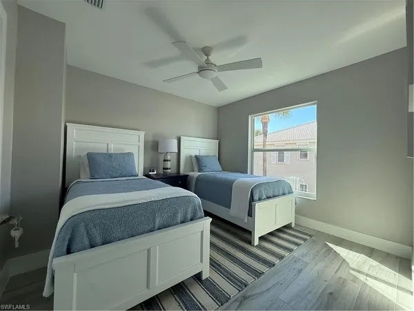 a bedroom with bed and window