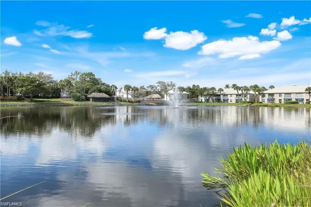 a view of a lake with houses in the back