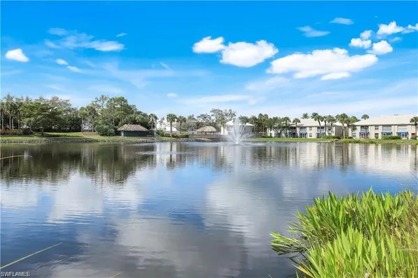 a view of a lake with houses in the back