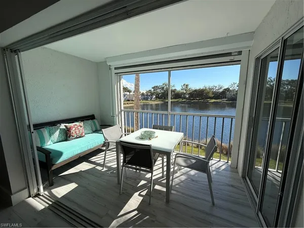a view of a porch with furniture and wooden floor