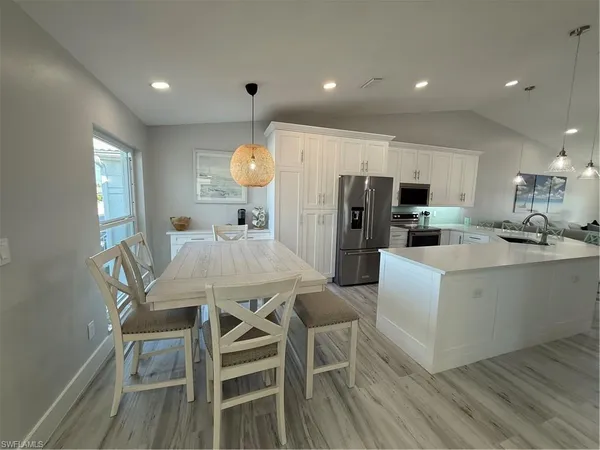 a view of a dining room with furniture and wooden floor