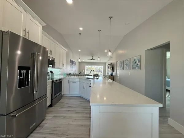 a kitchen with refrigerator and windows