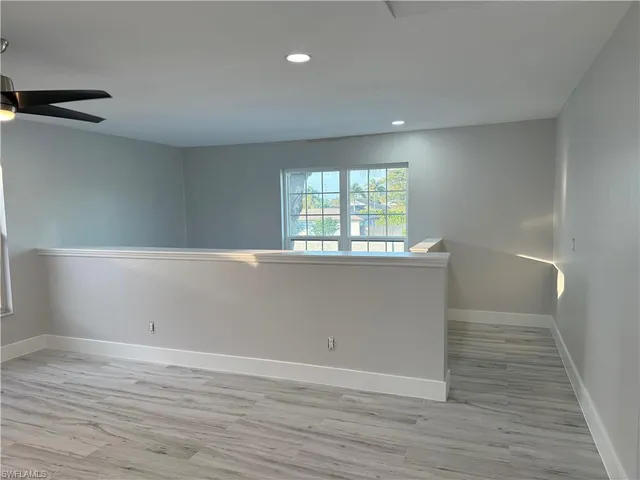 a view of a room with wooden floor