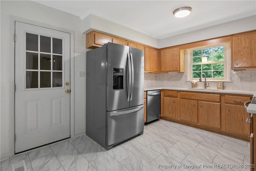 7118 Fillyaw Road Fayetteville, NC 28303 - Photo 16 of 45 a kitchen with stainless steel appliances granite countertop a refrigerator sink and cabinets